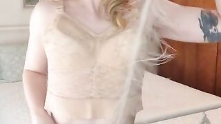Audrey Love pinup model in vintage lingerie plays with feather