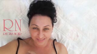 White socks. Cute chick lies on the bed, smiles, gracefully bends. Nice Baby with white socks on th