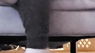 Taking off shoes after long day rubbing stinky feet in sweaty white socks