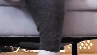 Taking off shoes after long day rubbing stinky feet in sweaty white socks