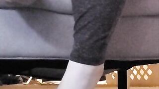 Taking off shoes after long day rubbing stinky feet in sweaty white socks