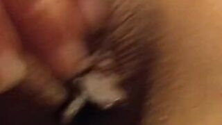 Cumshot on an Asian pussy while she caresses her clit