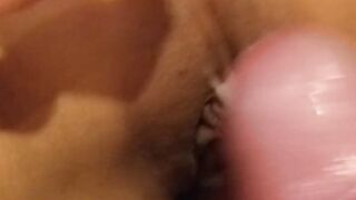 Cumshot on an Asian pussy while she caresses her clit
