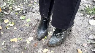 girl in high-heeled boots wants to go to home, but there is dirty slippery slide on the way
